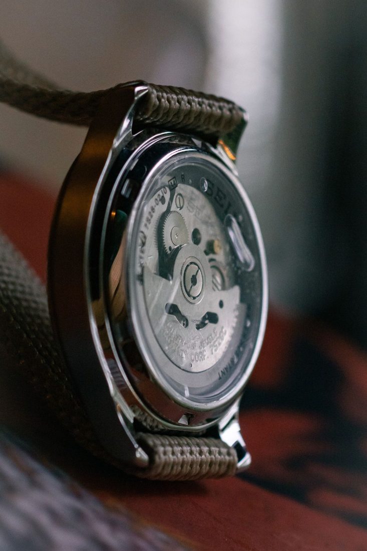 A close view of a wristwatch showing its mechanism.