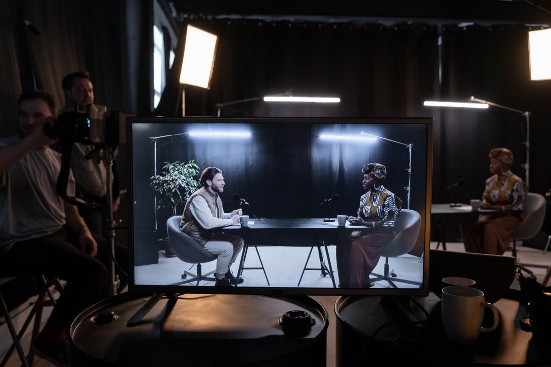 A production monitor showing two people in conversation.