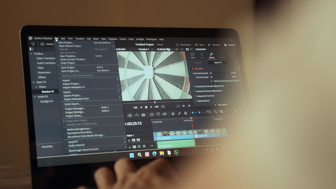 A laptop displaying video editing software.