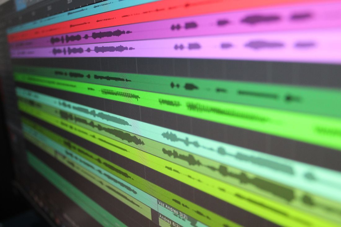 Coloured audio waveform tracks on a computer display.