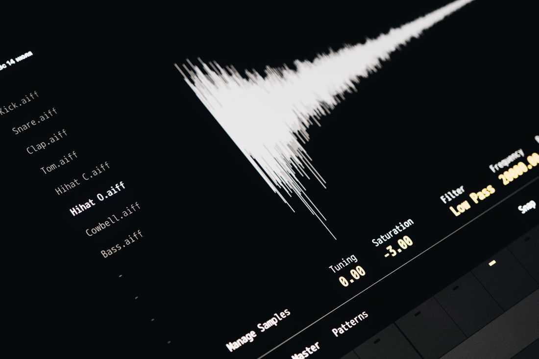 An audio waveform and file information on a dark screen.