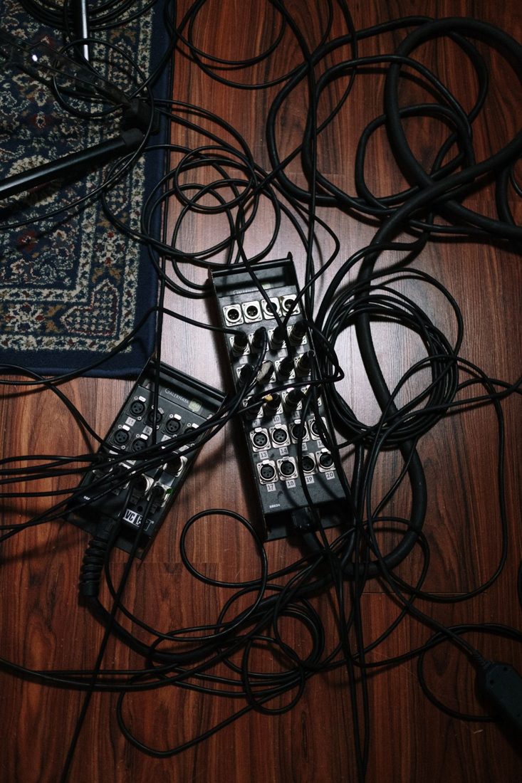 Audio cables crossing a patterned floor.