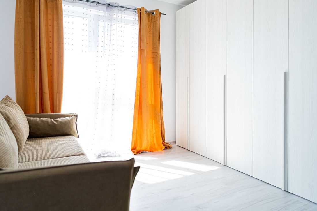 Curtains and a sofa in a bright living room.