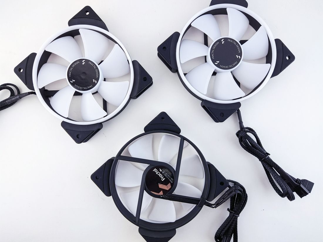 Three computer cooling fans with connecting cables.