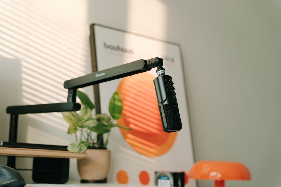 A microphone on an adjustable arm in a home office corner.