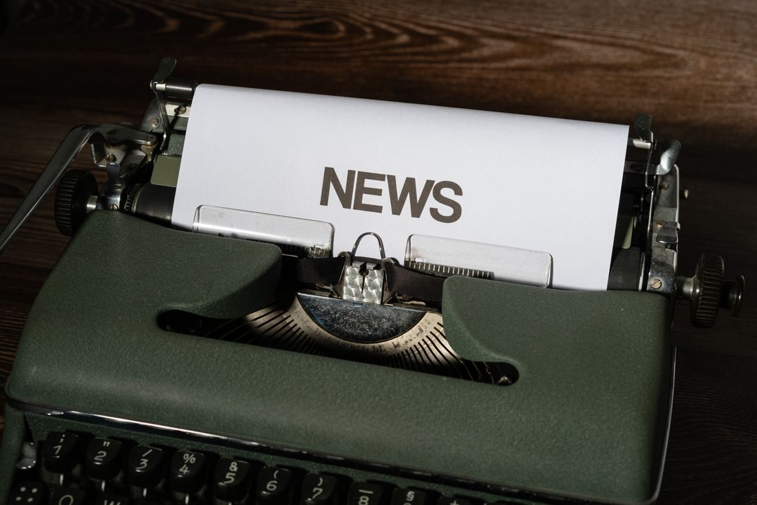 A typewriter with the word News printed on its paper.