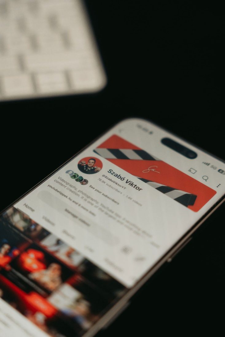 A phone displaying a video channel and thumbnail images.